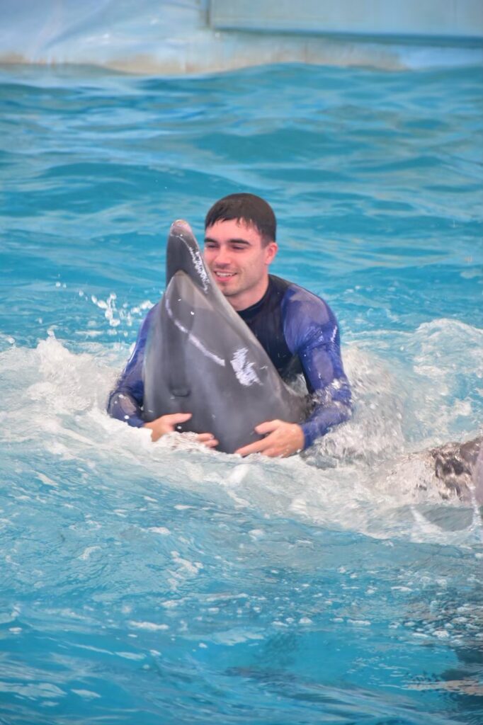 Guest swimming with a dolphin at Dolphins Bay Phuket