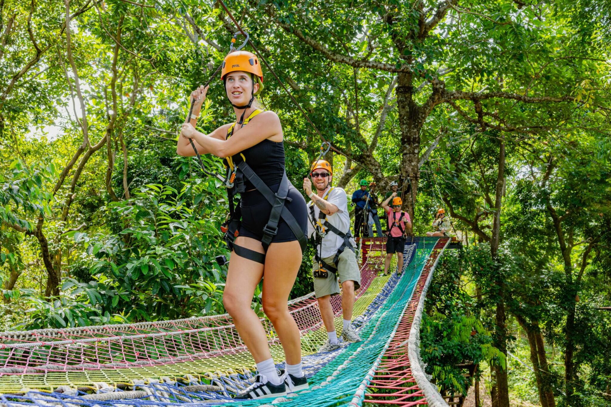 Guest crossing a net sky bridge in the Khao Lak jungle