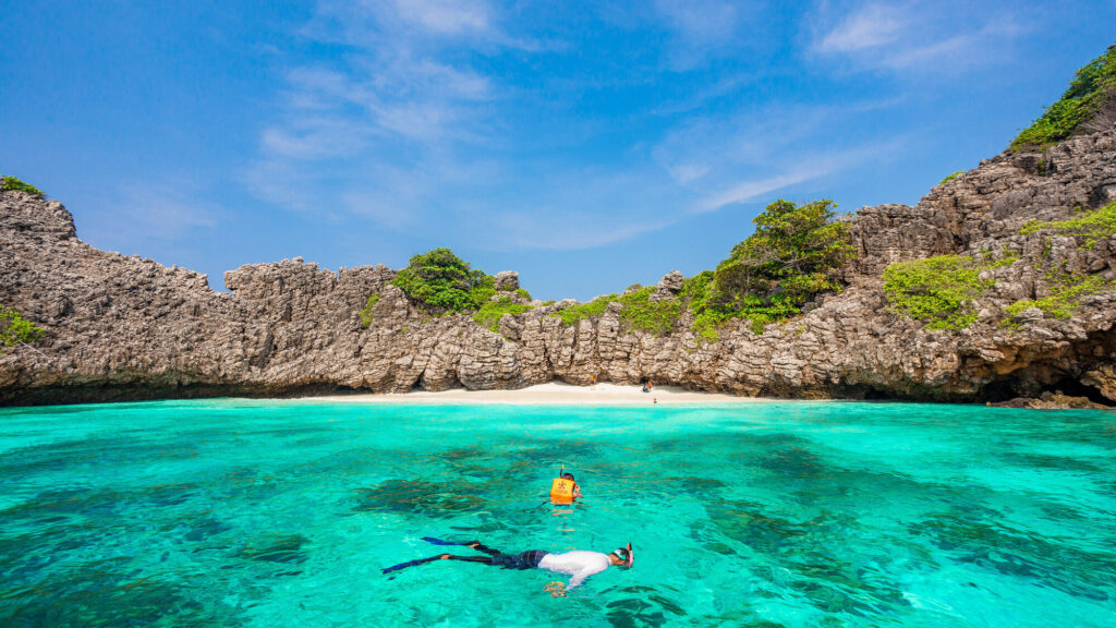 Snorkeller in the clear shallows off Koh Rok