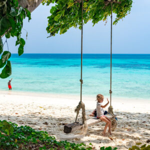 Rope swing on a white-sand beach at Koh Rok