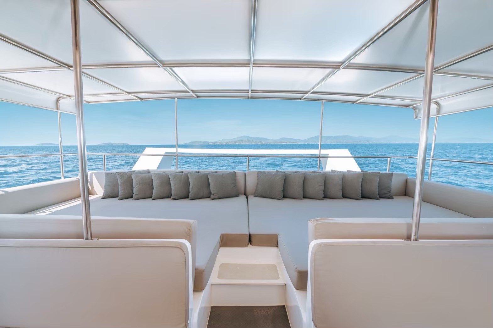 Rear lounge with cushioned seating on the yacht