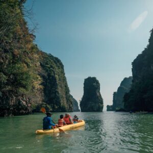 Sea kayaks paddling between limestone karsts in Phang Nga Bay