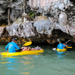 Guides paddling guests through a sea cave