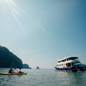 Sea kayak near the tour boat in Phang Nga Bay