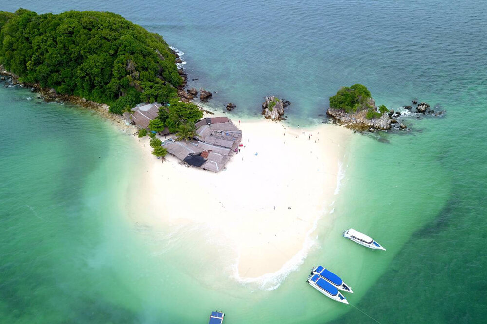 White sandbar at Khai Island with speedboats moored