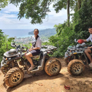 Two ATVs parked at a viewpoint above the sea