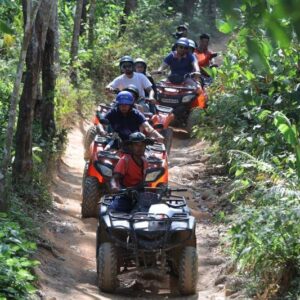 Line of ATVs on a jungle trail