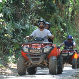 ATV driver and passenger on the trail