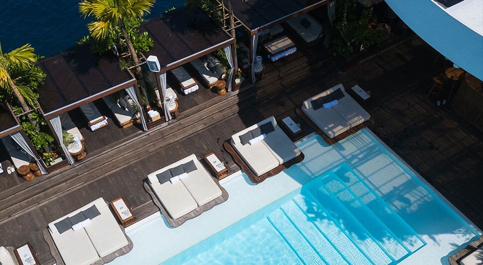 Aerial view of pool daybeds and cabanas