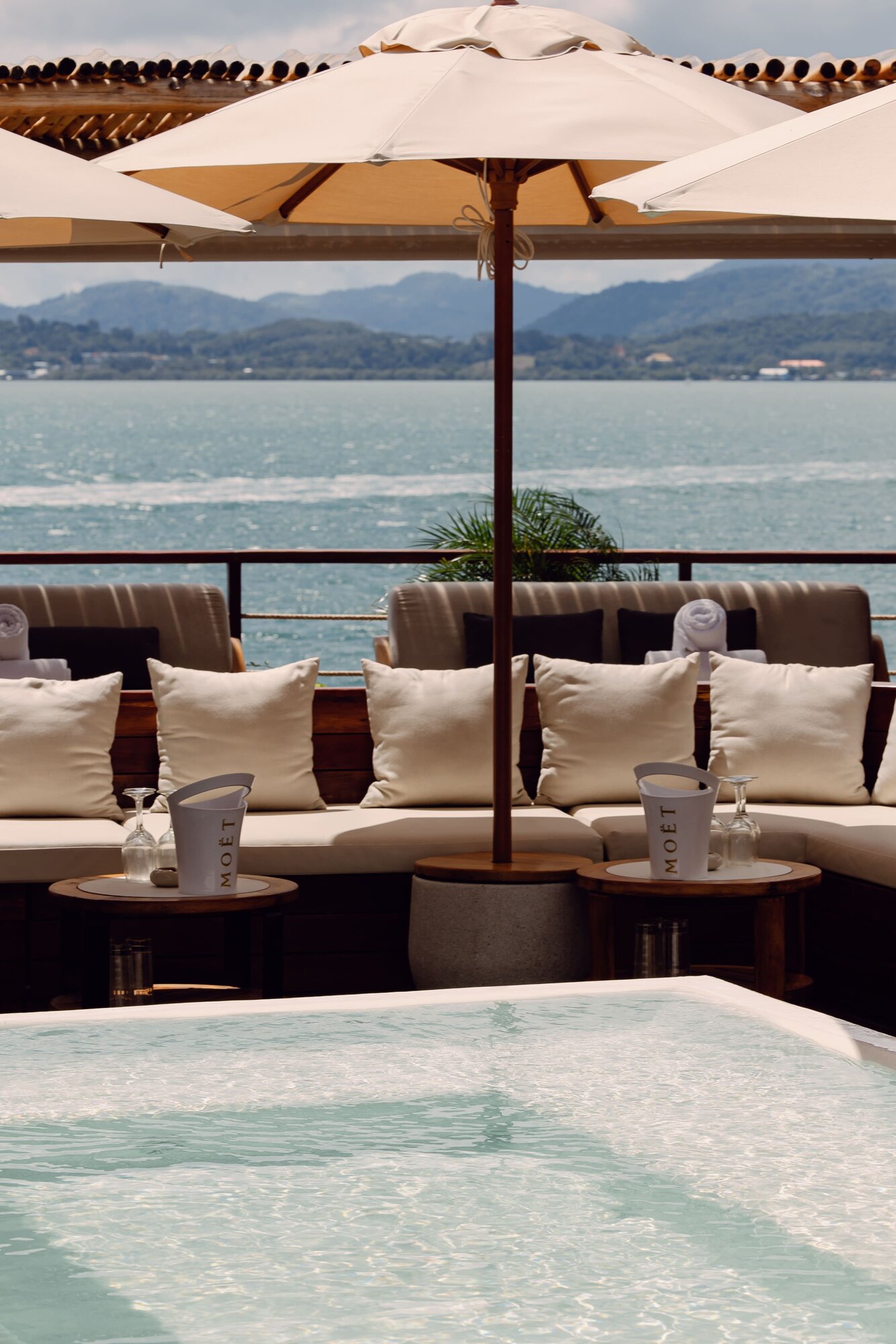 Terrace with umbrellas and a plunge pool facing the sea