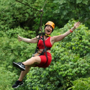 Smiling zipline rider in the rainforest