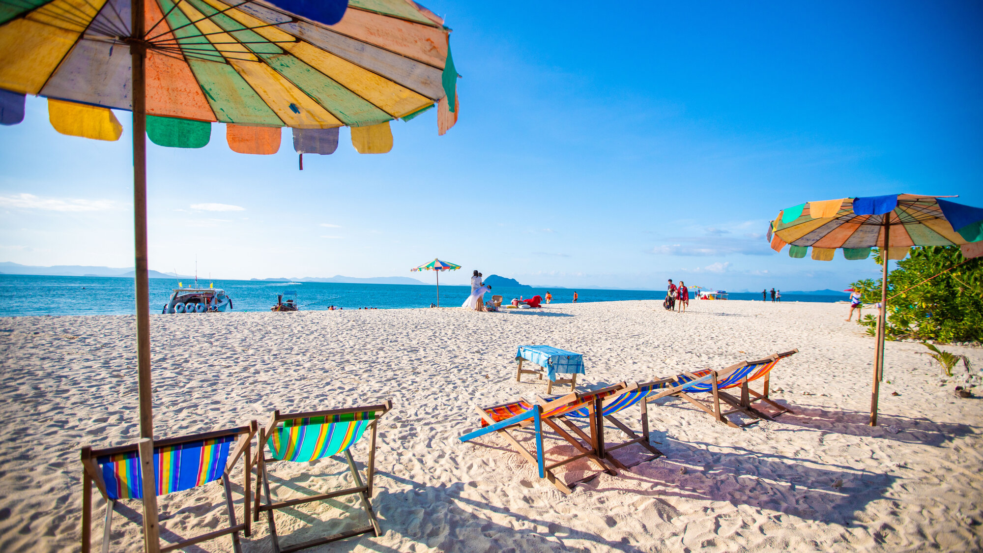 Beach chairs and umbrellas on white sand at Khai Island