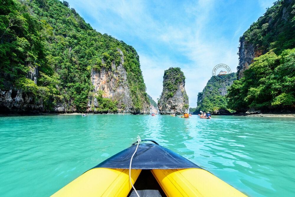 View from a canoe gliding toward the karsts of Phang Nga Bay