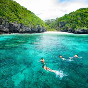 Snorkellers in the emerald water of Pileh Lagoon, Phi Phi Leh