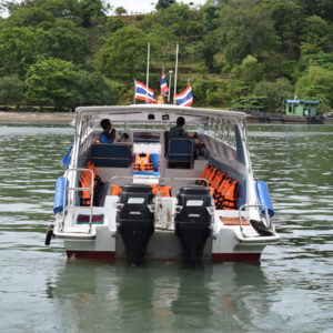 Private twin-engine speedboat waiting offshore for its group
