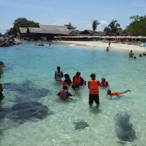 Guests snorkelling in clear shallow water at Khai Island