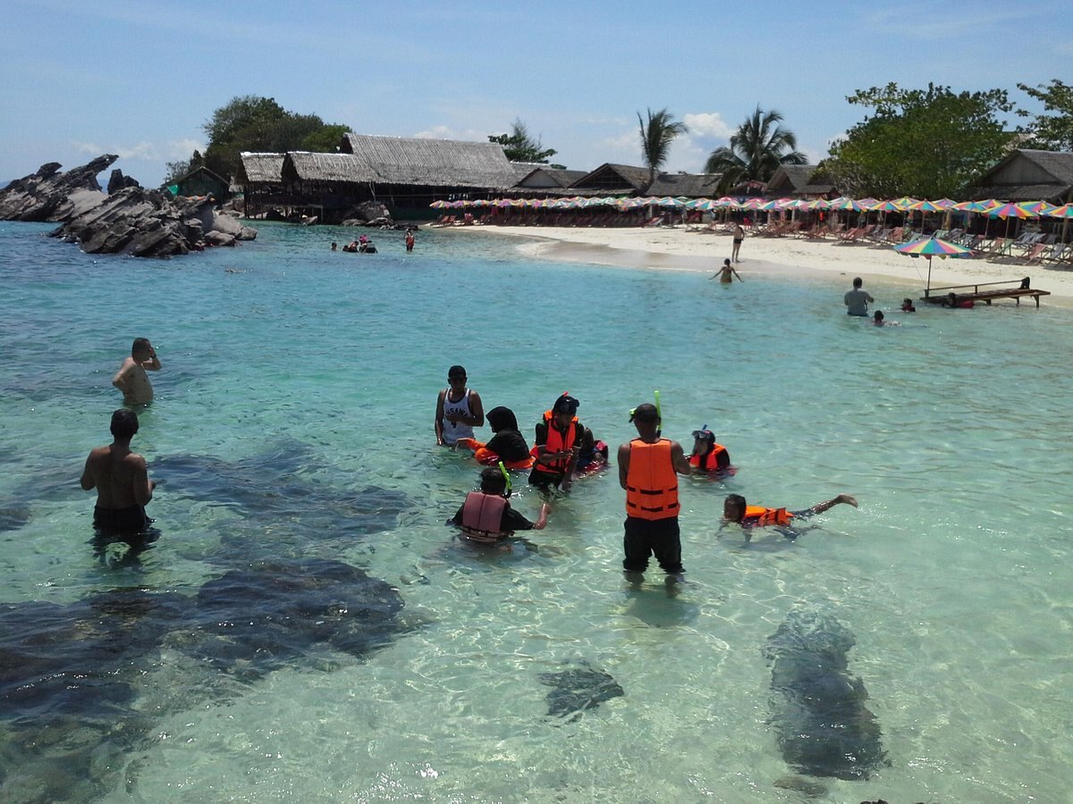 Guests snorkelling in clear shallow water at Khai Island