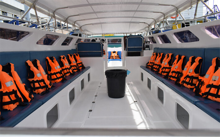 Shaded seating and life jackets inside a private speedboat