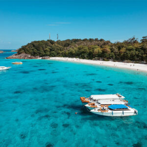Speedboats anchored off a white beach in the Similan Islands