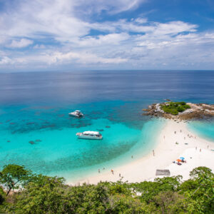 Hilltop view over a white sandbar and turquoise bay