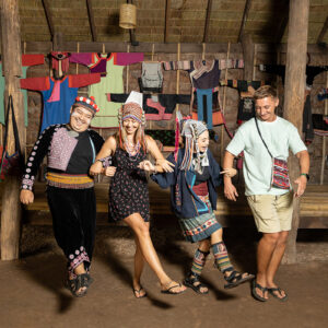Visitors in hill-tribe dress at the Siam Niramit village