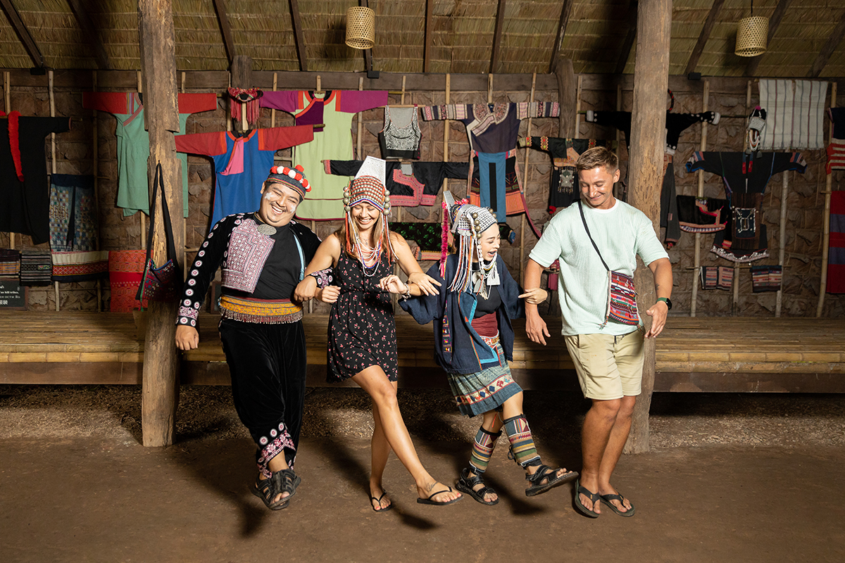 Visitors in hill-tribe dress at the Siam Niramit village