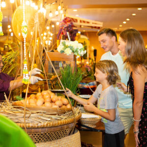 Family choosing Thai food at the Siam Niramit dinner