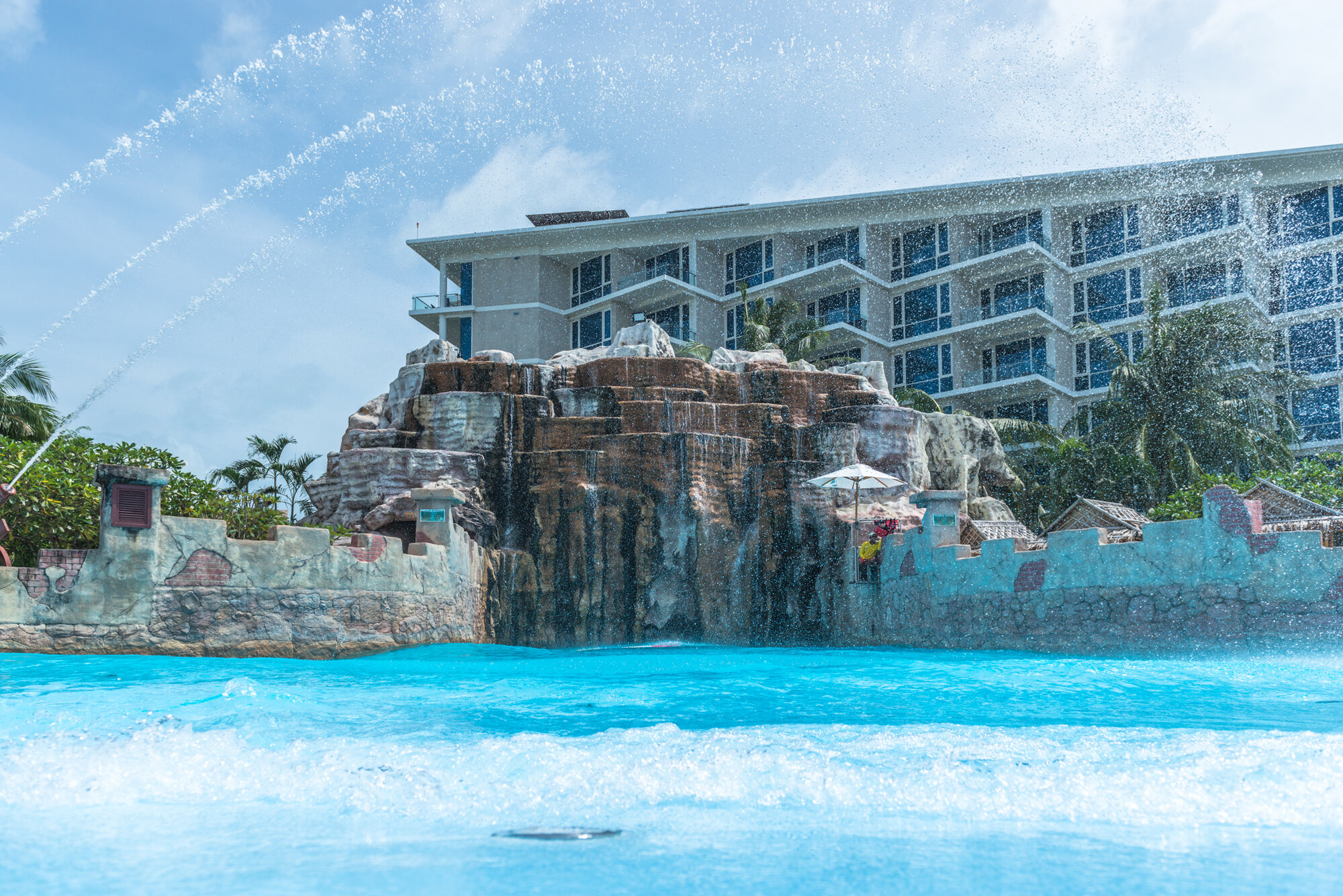 Wave pool with rock waterfall at Splash Jungle Water Park in Mai Khao, Phuket