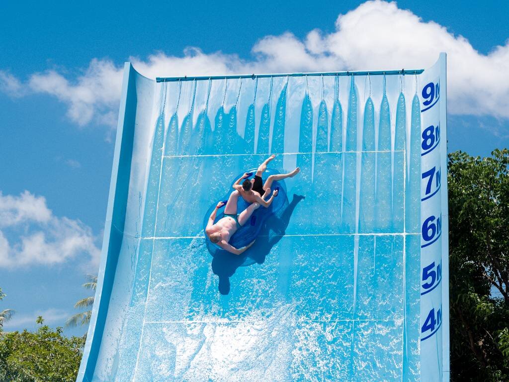 Guest riding a steep wave slide at Splash Jungle Water Park, Phuket