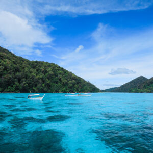 Turquoise water and forested hills in the Surin Islands