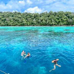 Snorkellers in clear water at the Surin Islands