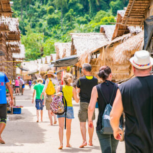 Visitors walking through the Moken sea gypsy village